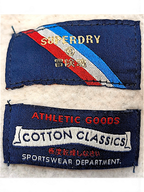 JAKE & IPI Superdry College sweatshirt interior brand and care labels with red, white, and blue diagonal stripe