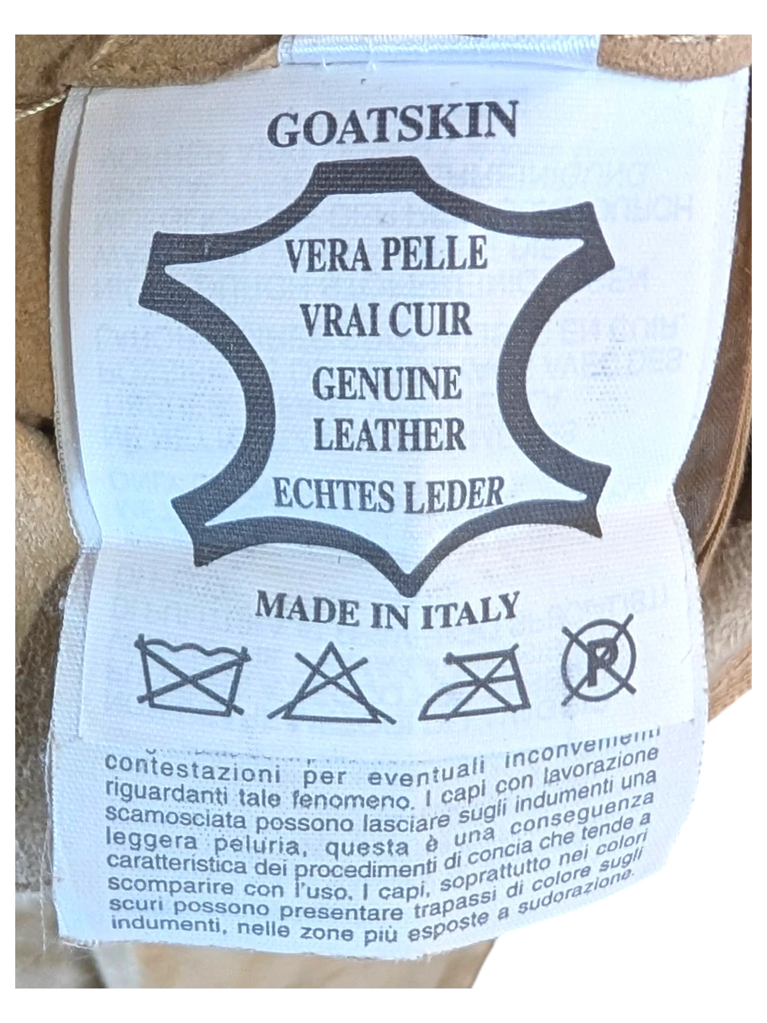 JAKE & IPI tan suede goatskin leather pants interior label showing Made in Italy and genuine leather certification