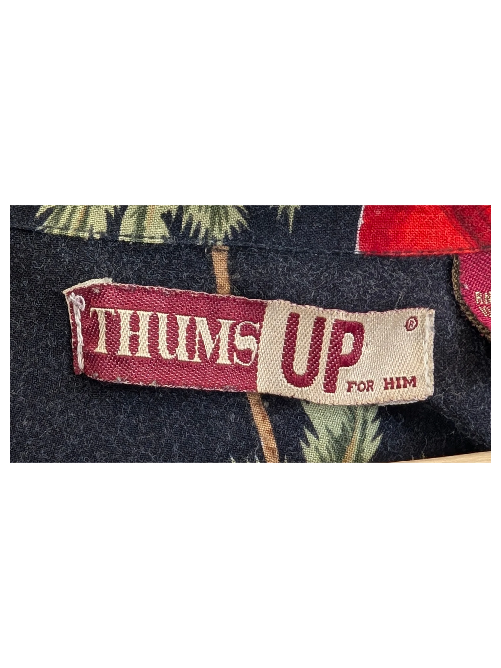JAKE & IPI Thums UP Hawaiian shirt featuring a black fabric with green palm tree and red floral print details.