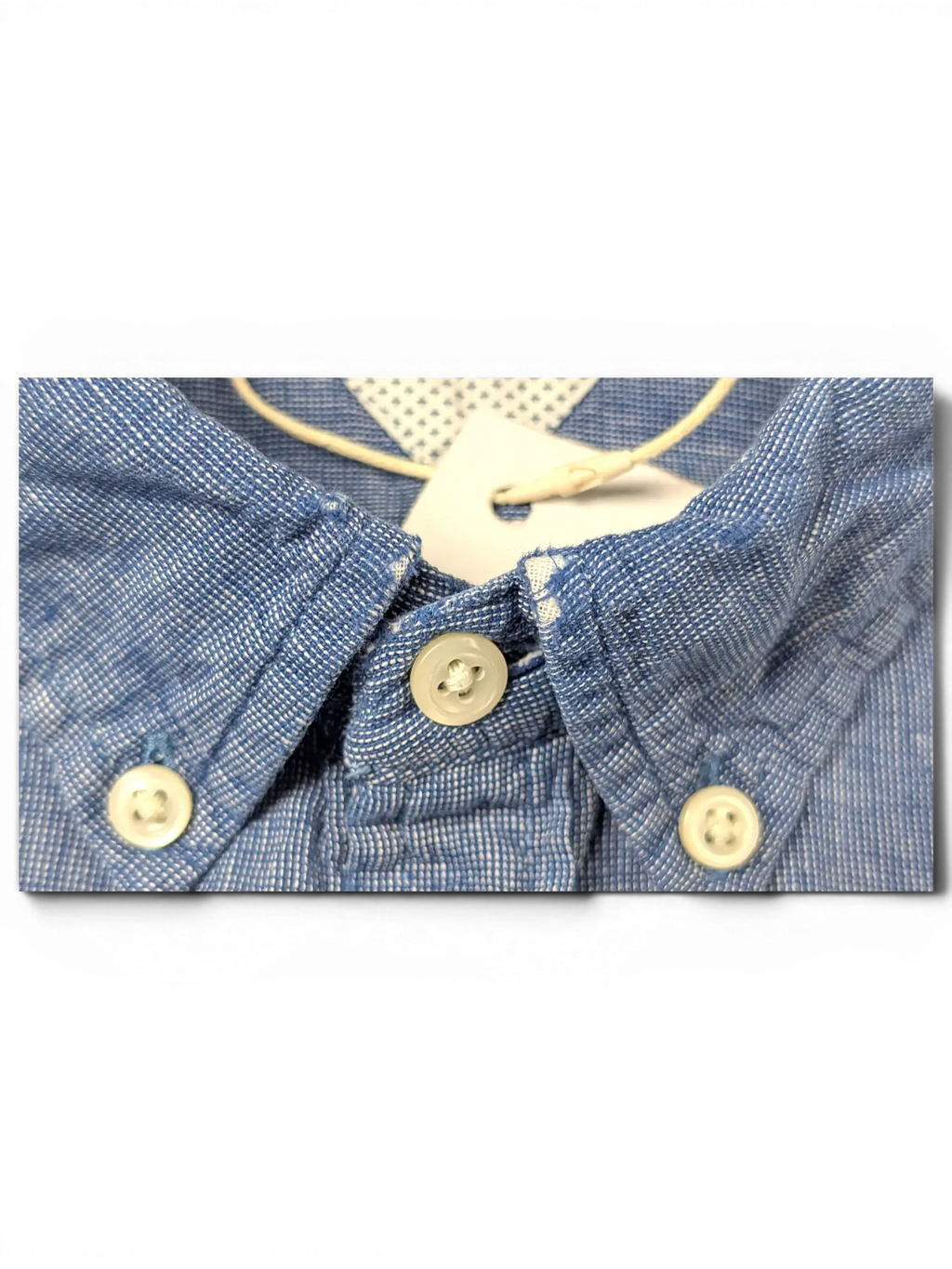JAKE & IPI Tommy Hilfiger blue button-up shirt with a textured fabric and white button-down collar detail.