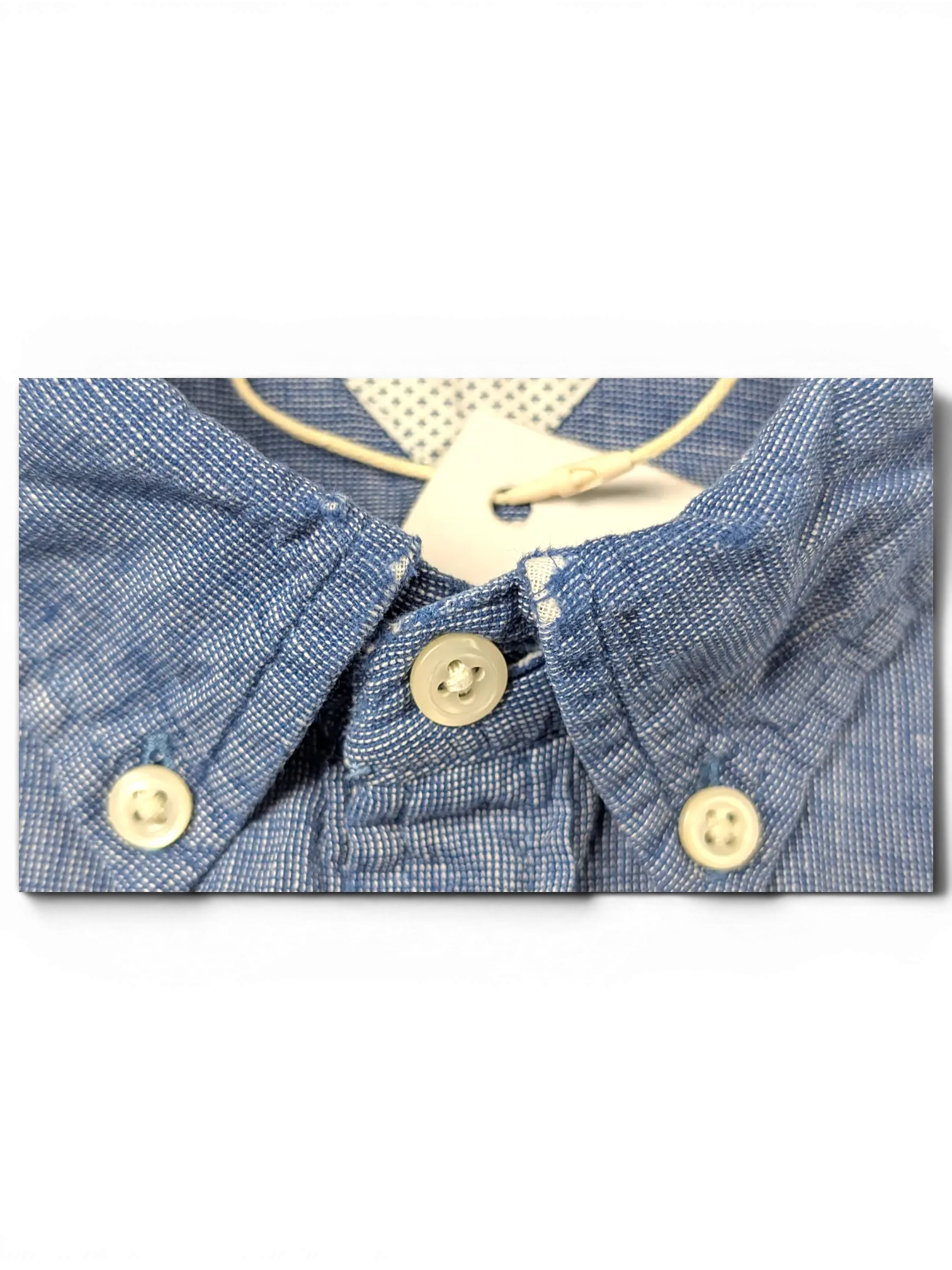 JAKE & IPI Tommy Hilfiger blue button-up shirt with a textured fabric and white button-down collar detail.