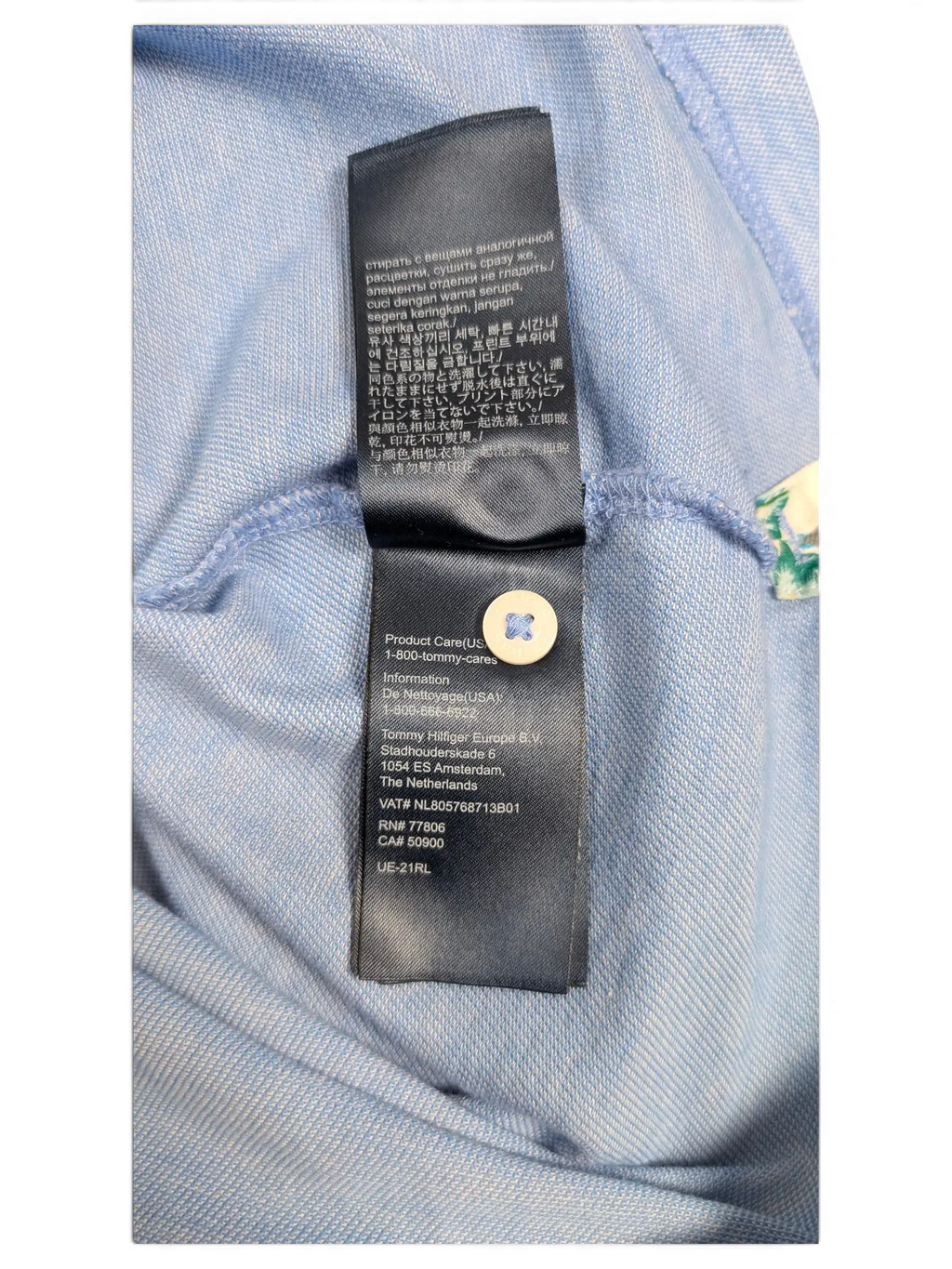 JAKE & IPI Tommy Hilfiger light blue polo shirt interior care label with brand information and washing instructions