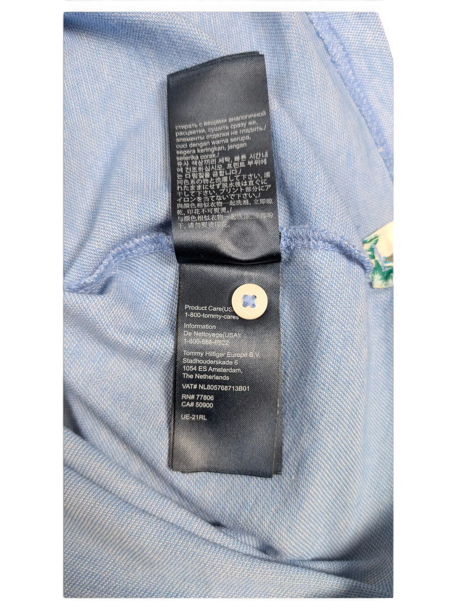 JAKE & IPI Tommy Hilfiger light blue polo shirt interior care label with brand information and washing instructions