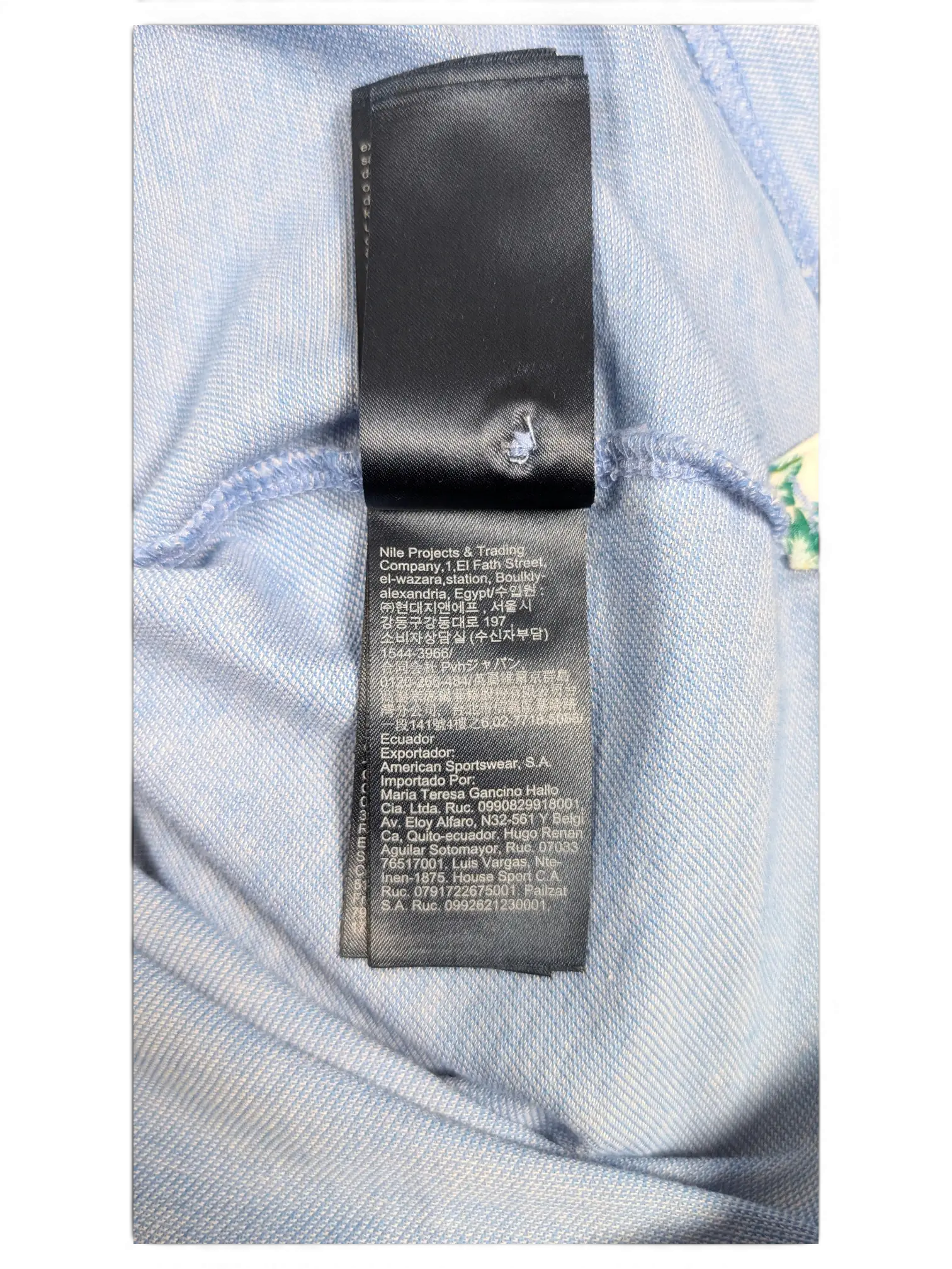 JAKE & IPI Tommy Hilfiger light blue polo shirt interior care label with multi-language manufacturing information