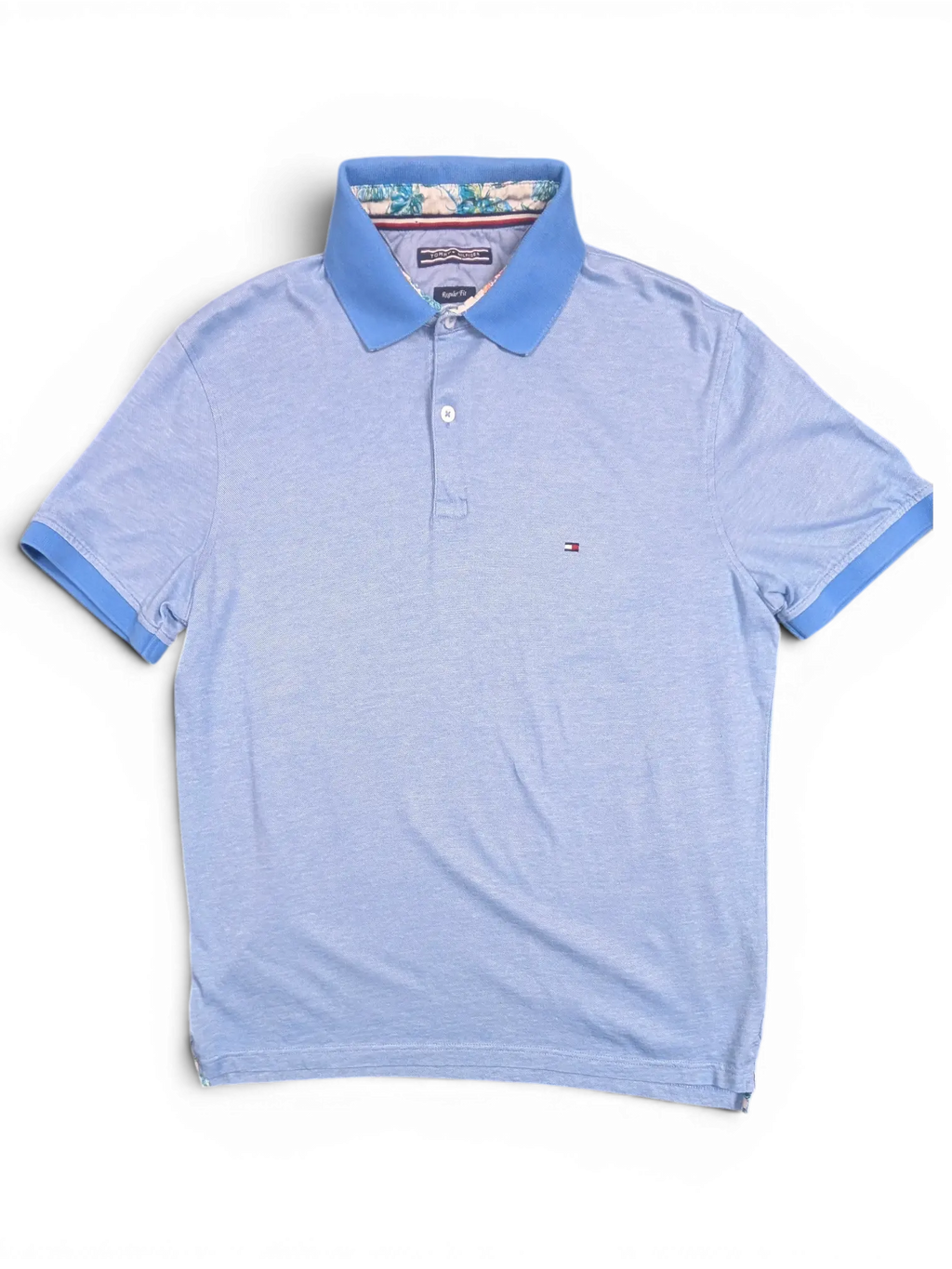 JAKE & IPI pre-owned light blue Tommy Hilfiger polo shirt with embroidered flag logo and patterned collar lining.