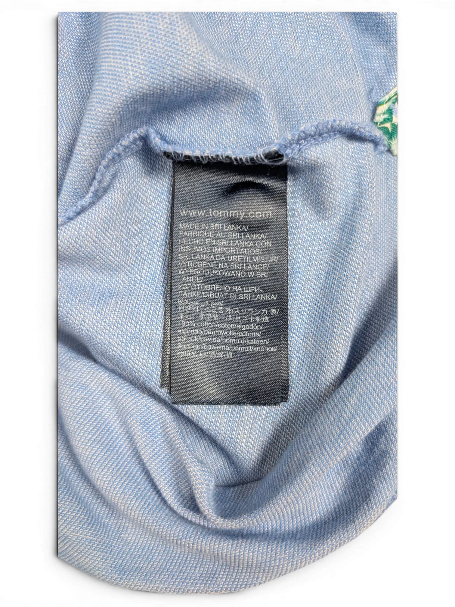 JAKE & IPI Tommy Hilfiger light blue polo shirt interior care label made of 100% cotton in Sri Lanka