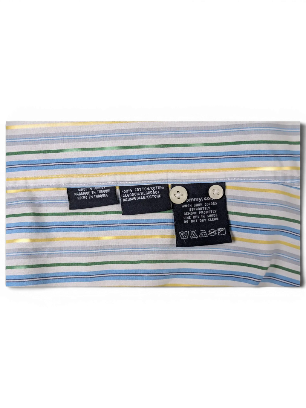 JAKE & IPI Tommy Hilfiger shirt interior labels showing 100% cotton material and care instructions on striped fabric