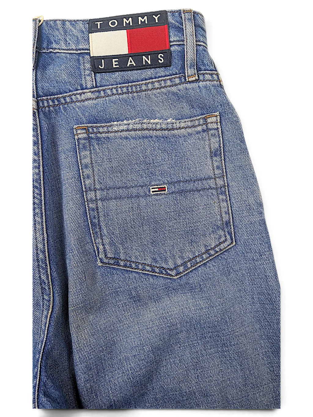 JAKE & IPI Tommy Jeans blue denim jeans featuring a classic back pocket with embroidered logo patch and flag detail.