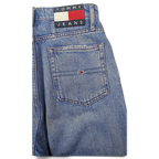 JAKE & IPI Tommy Jeans blue denim jeans featuring a classic back pocket with embroidered logo patch and flag detail.