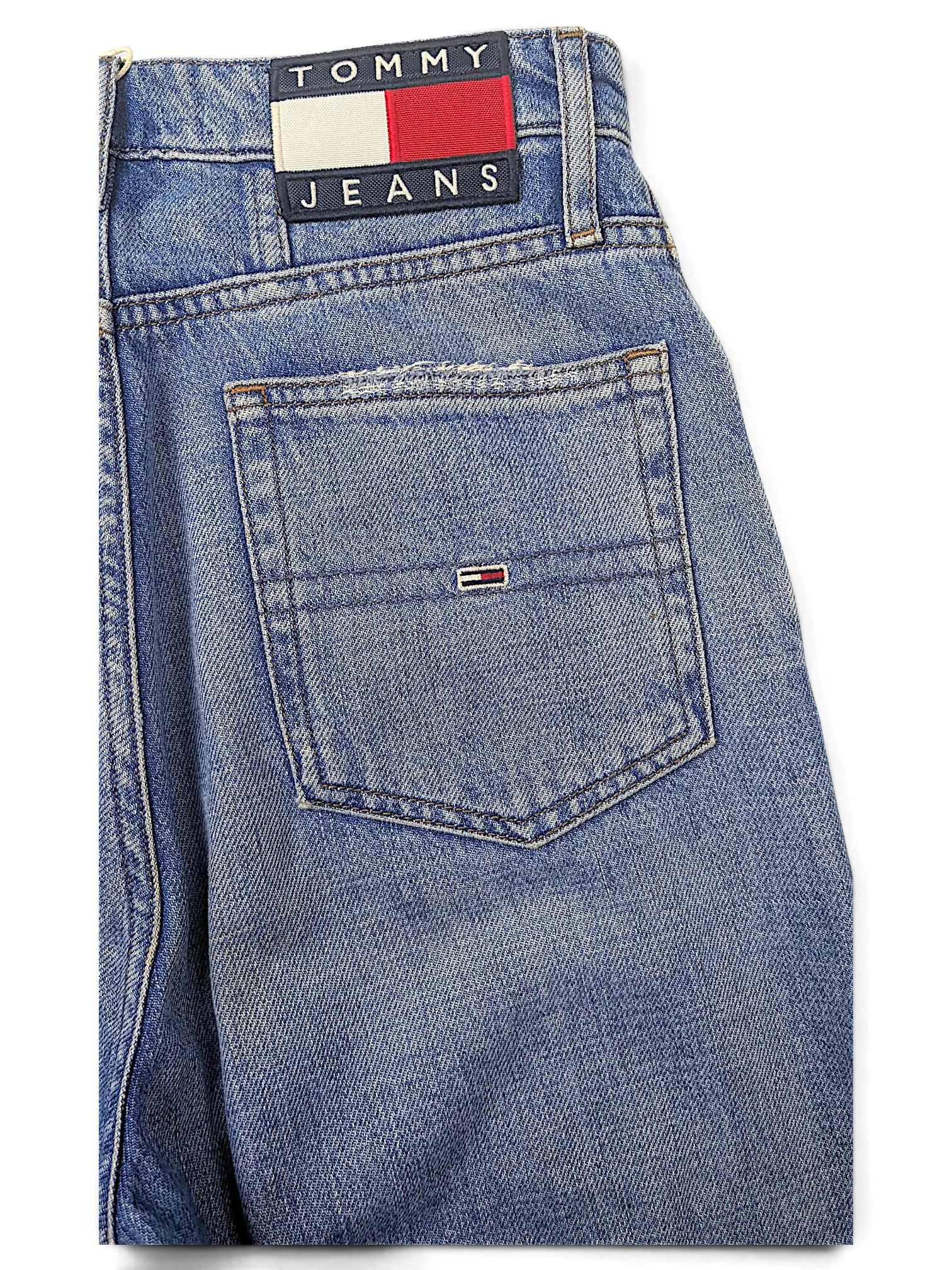 JAKE & IPI Tommy Jeans blue denim jeans featuring a classic back pocket with embroidered logo patch and flag detail.