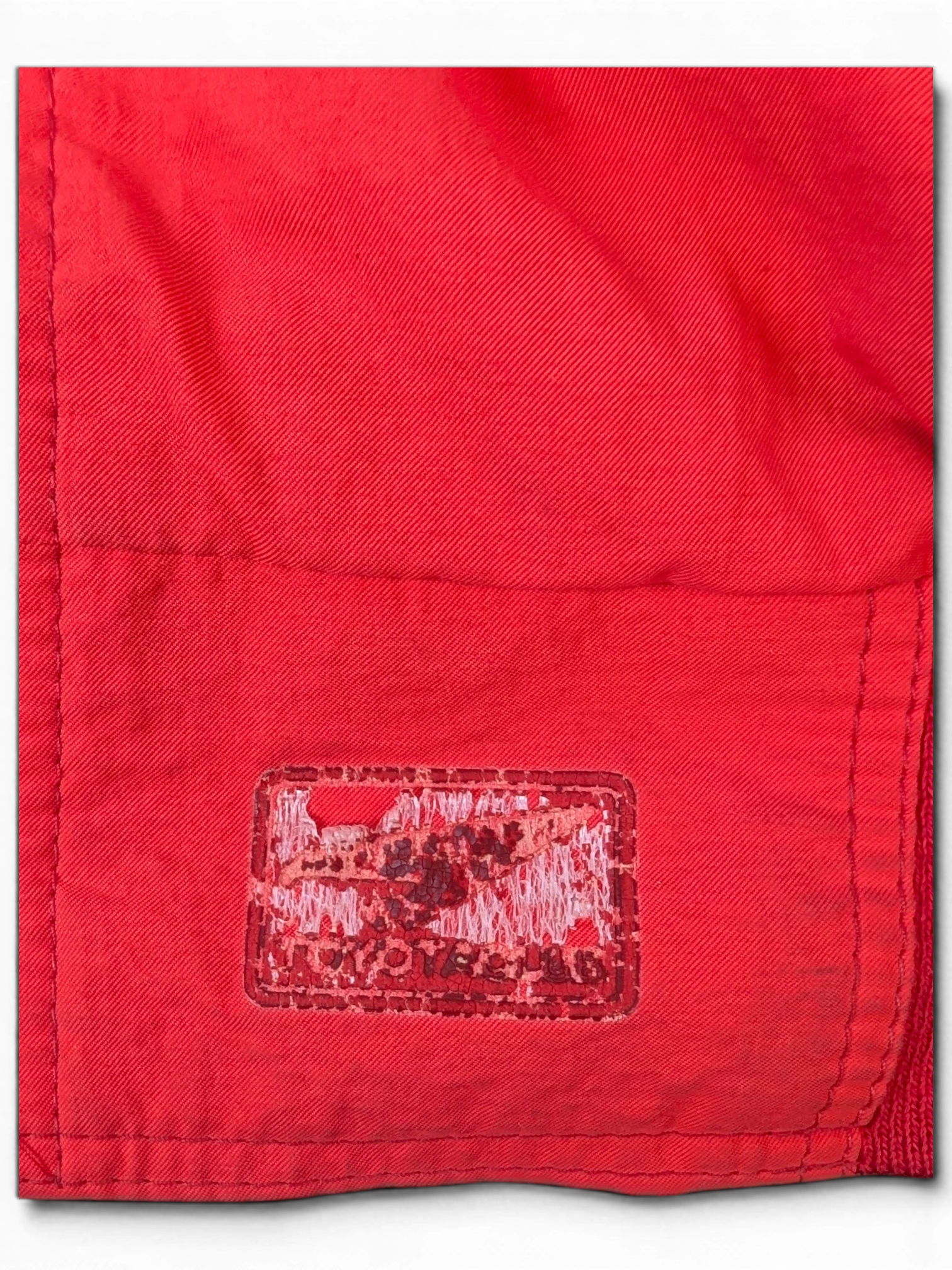 JAKE & IPI red fabric featuring a distressed Toyota club embroidered patch detail