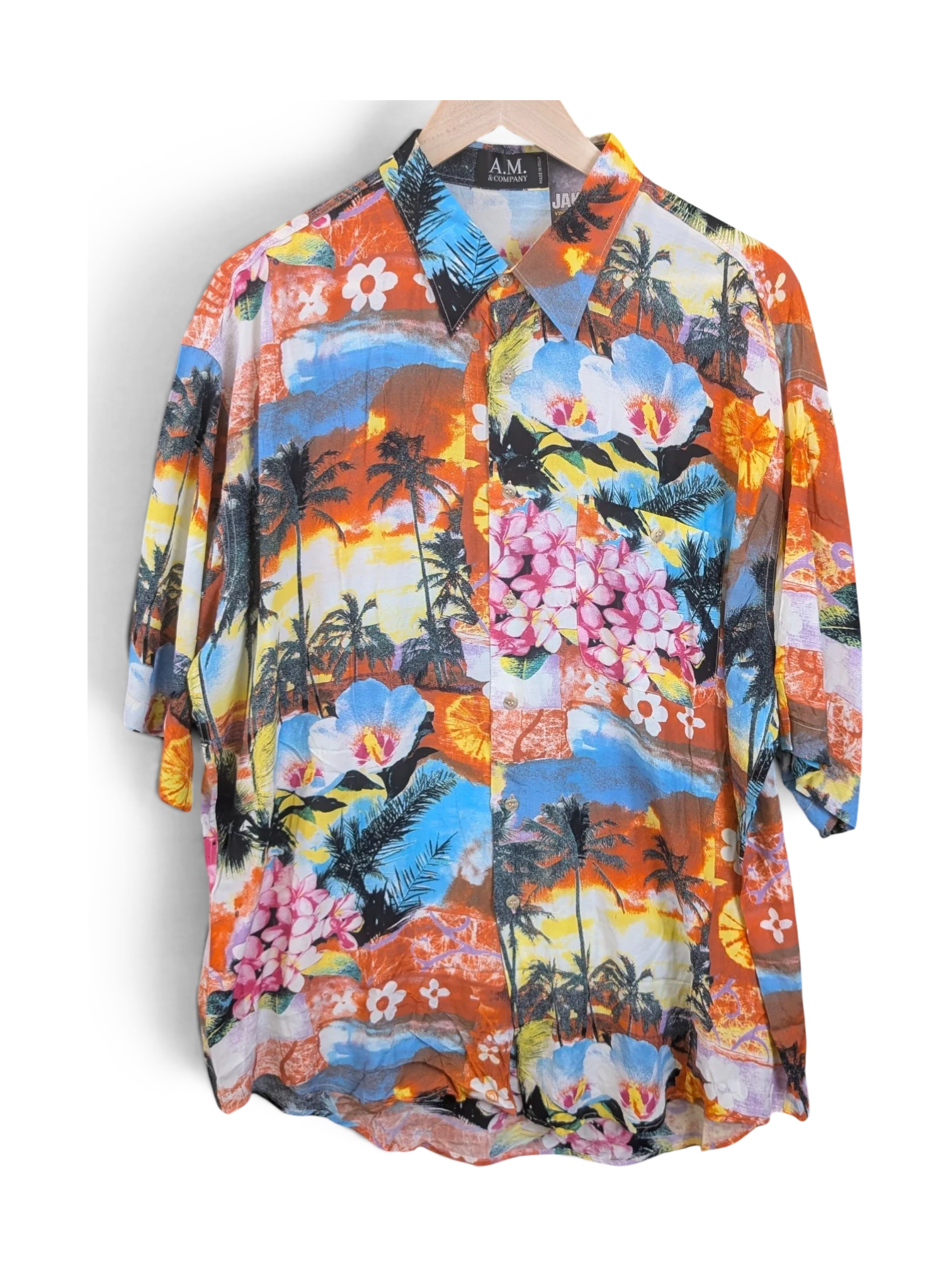 JAKE & IPI A.M. & Company short-sleeve Hawaiian shirt featuring a vibrant tropical sunset, palm tree, and floral print.