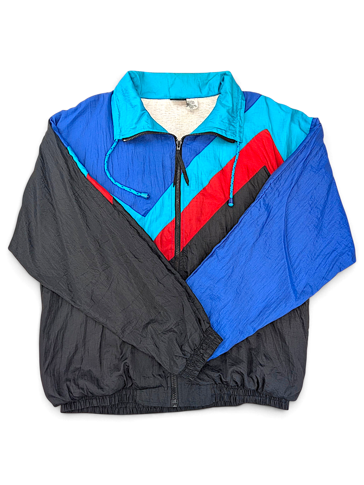 Turnpoint Sports Blue Chevron Windbreaker; Front view with blue, black, turquoise and red chevron panels.