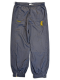 JAKE & IPI pre-owned navy Umbro track pants with yellow lion graphic and contrast panelling, size L.