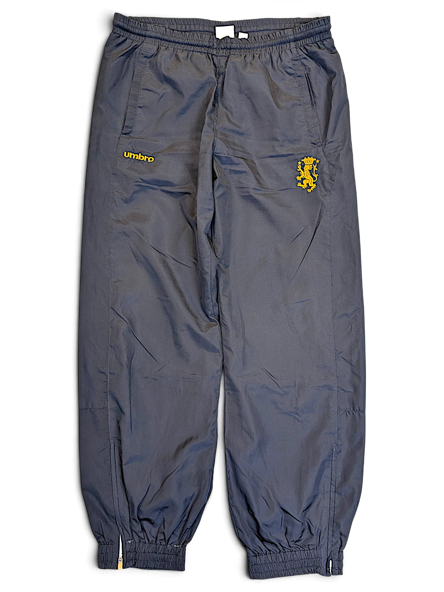 JAKE & IPI pre-owned navy Umbro track pants with yellow lion graphic and contrast panelling, size L.