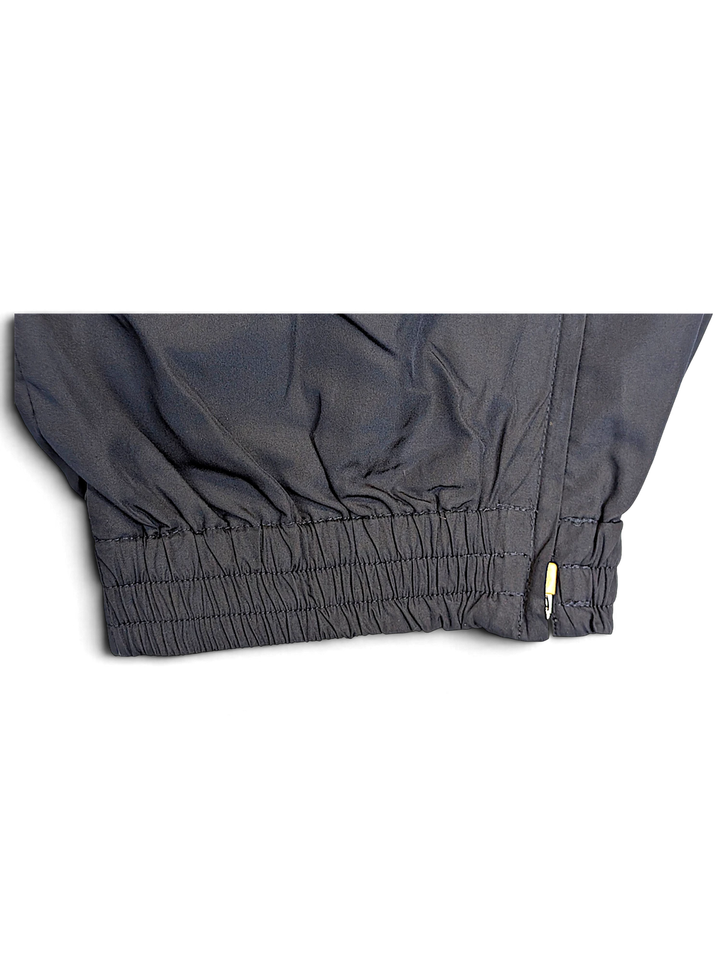 JAKE & IPI Umbro navy track pants featuring an elasticated ankle cuff with a small side zipper detail.
