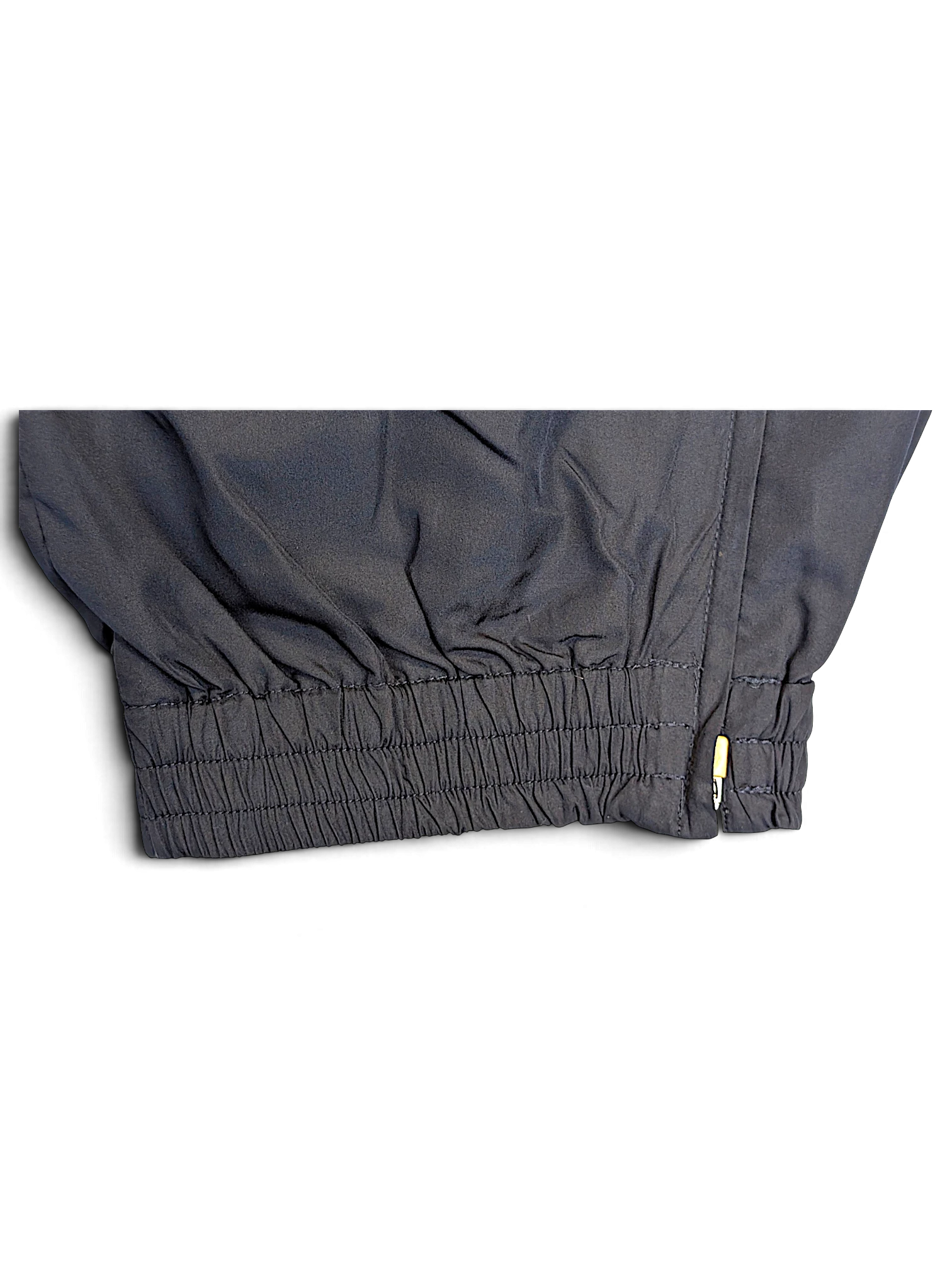 JAKE & IPI Umbro navy track pants featuring an elasticated ankle cuff with a small side zipper detail.