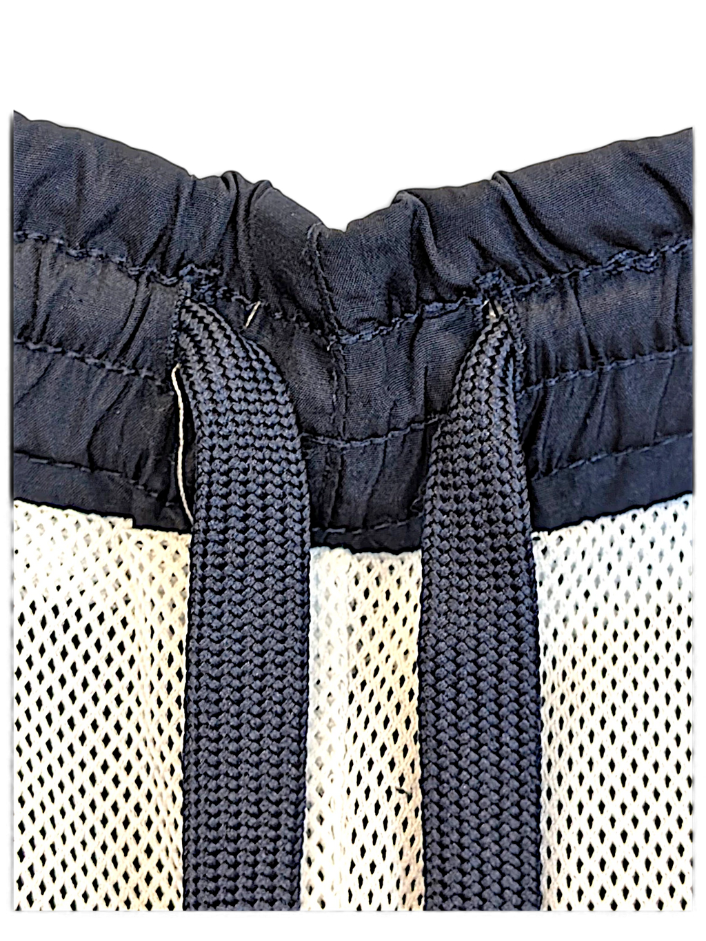 JAKE & IPI Umbro navy track pants featuring a drawstring elastic waistband and white mesh lining detail.