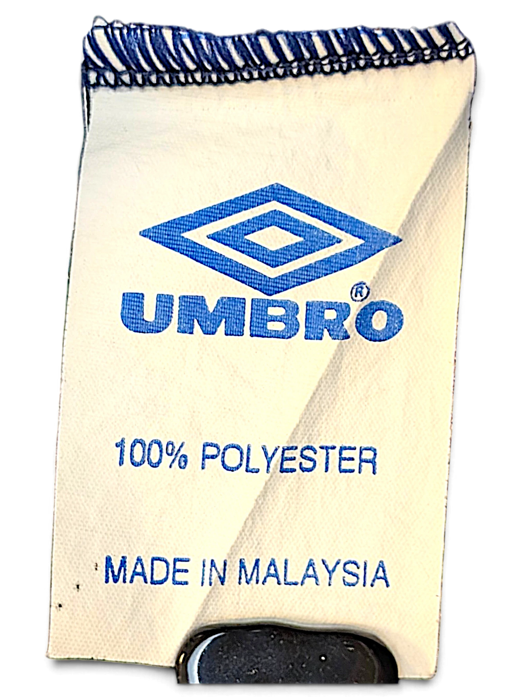 JAKE & IPI Umbro track pants clothing label showing 100% polyester material and made in Malaysia origin