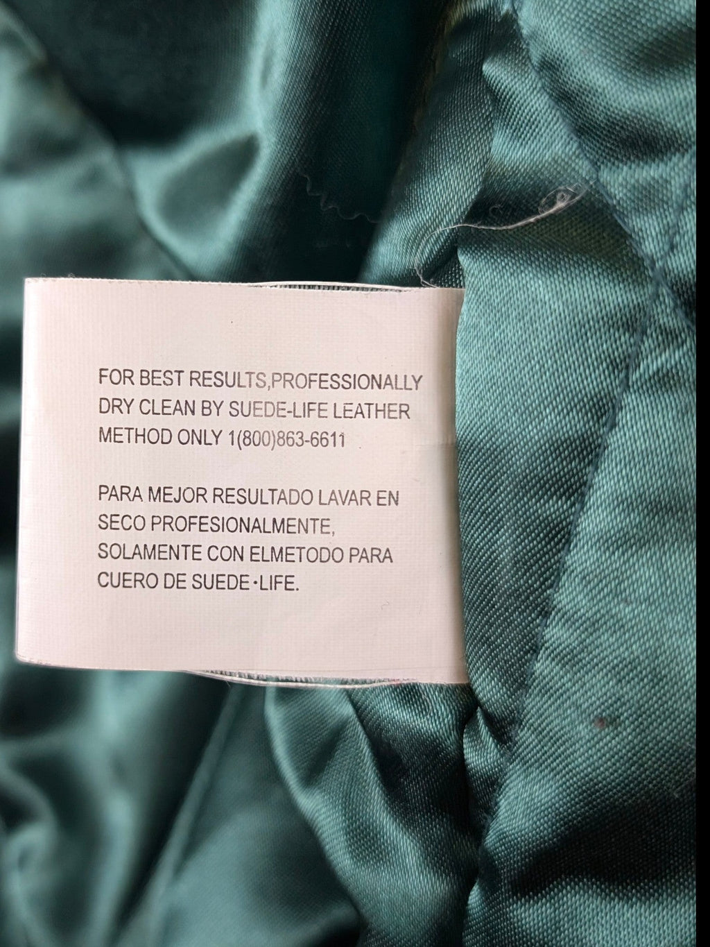 JAKE & IPI IBE Jeff Hamilton varsity jacket care label with dry clean instructions on green satin lining