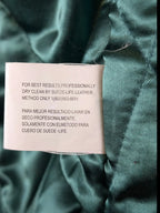 JAKE & IPI IBE Jeff Hamilton varsity jacket care label with dry clean instructions on green satin lining