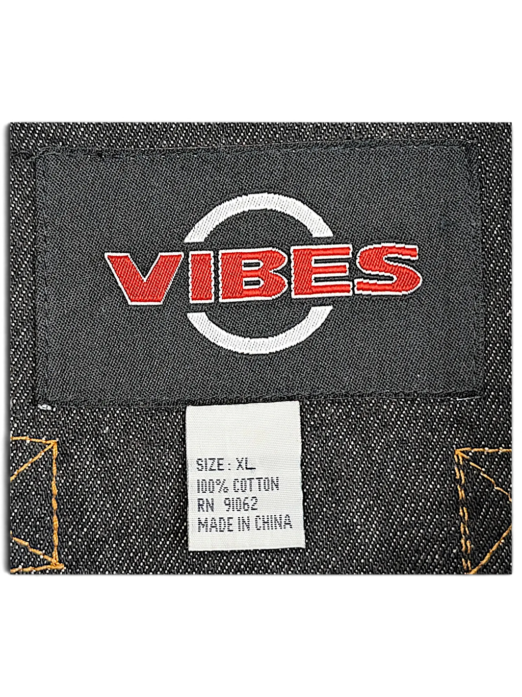JAKE & IPI VIBES denim jacket interior label showing 100% cotton material and size XL on dark blue fabric