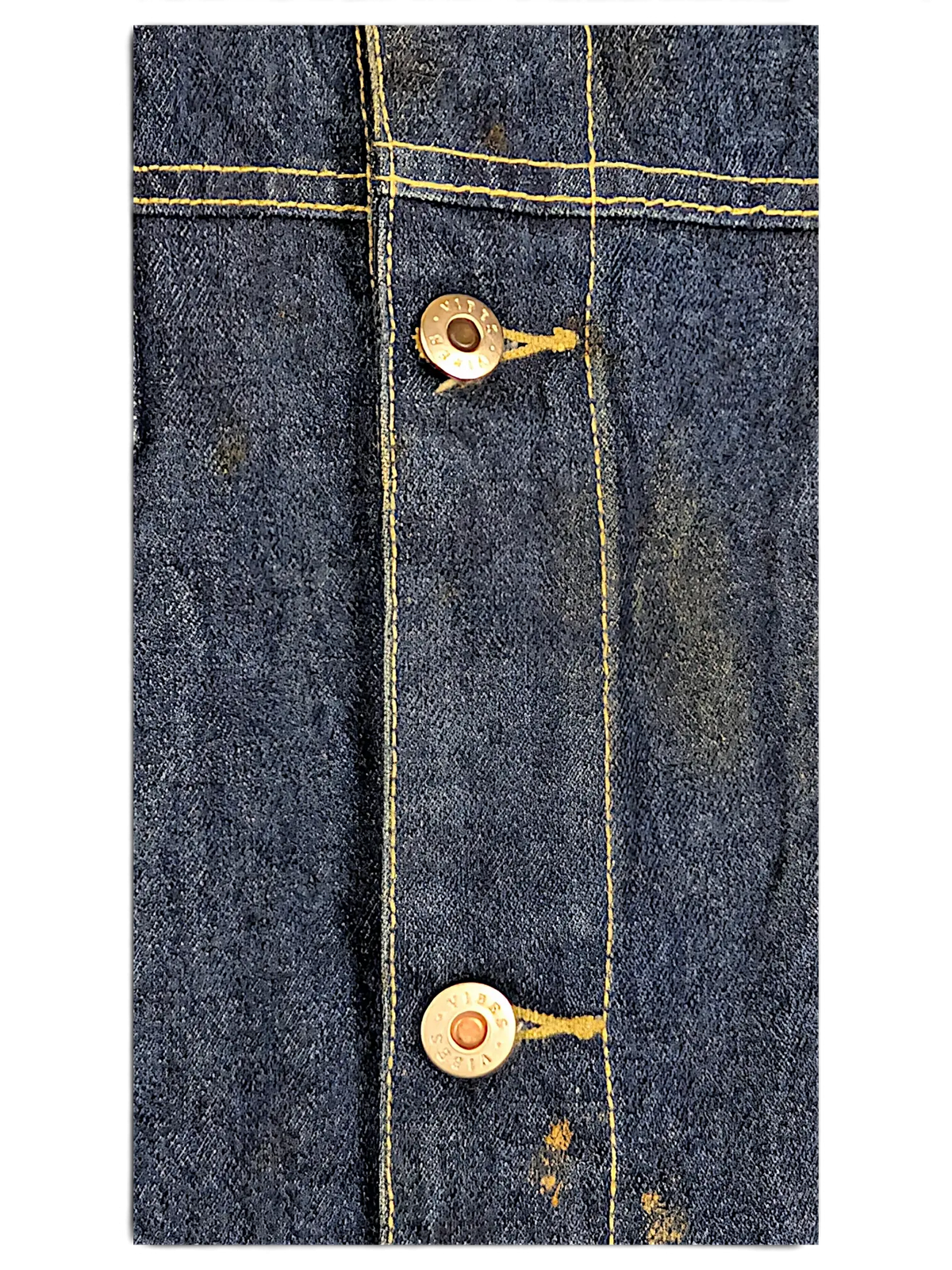 Close-up of JAKE & IPI Vibes denim vest featuring dark blue fabric, yellow contrast stitching, and branded metal buttons