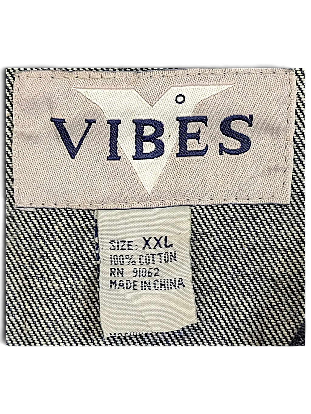 JAKE & IPI Vibes denim vest interior label showing size XXL and 100 percent cotton material composition