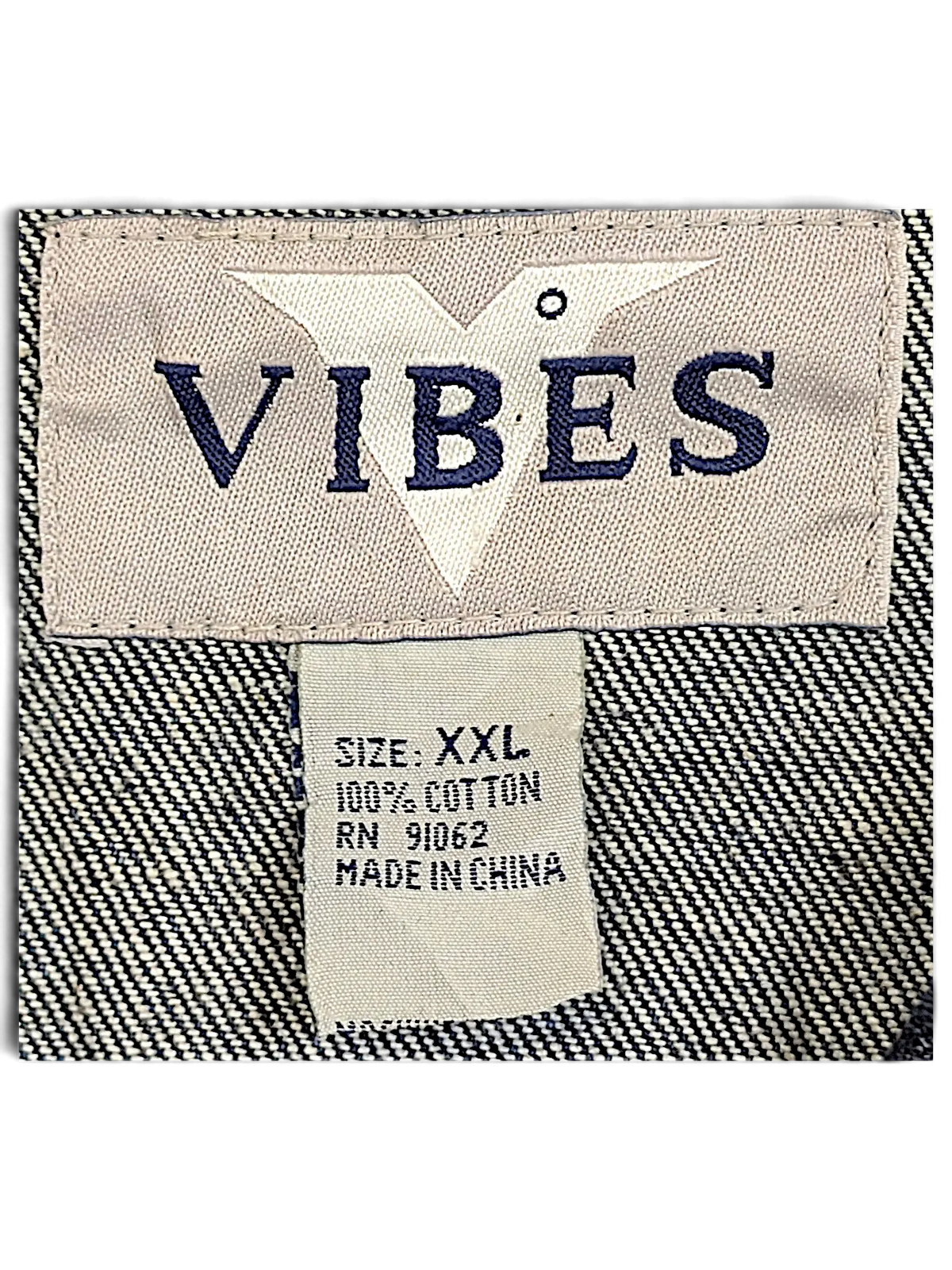 JAKE & IPI Vibes denim vest interior label showing size XXL and 100 percent cotton material composition