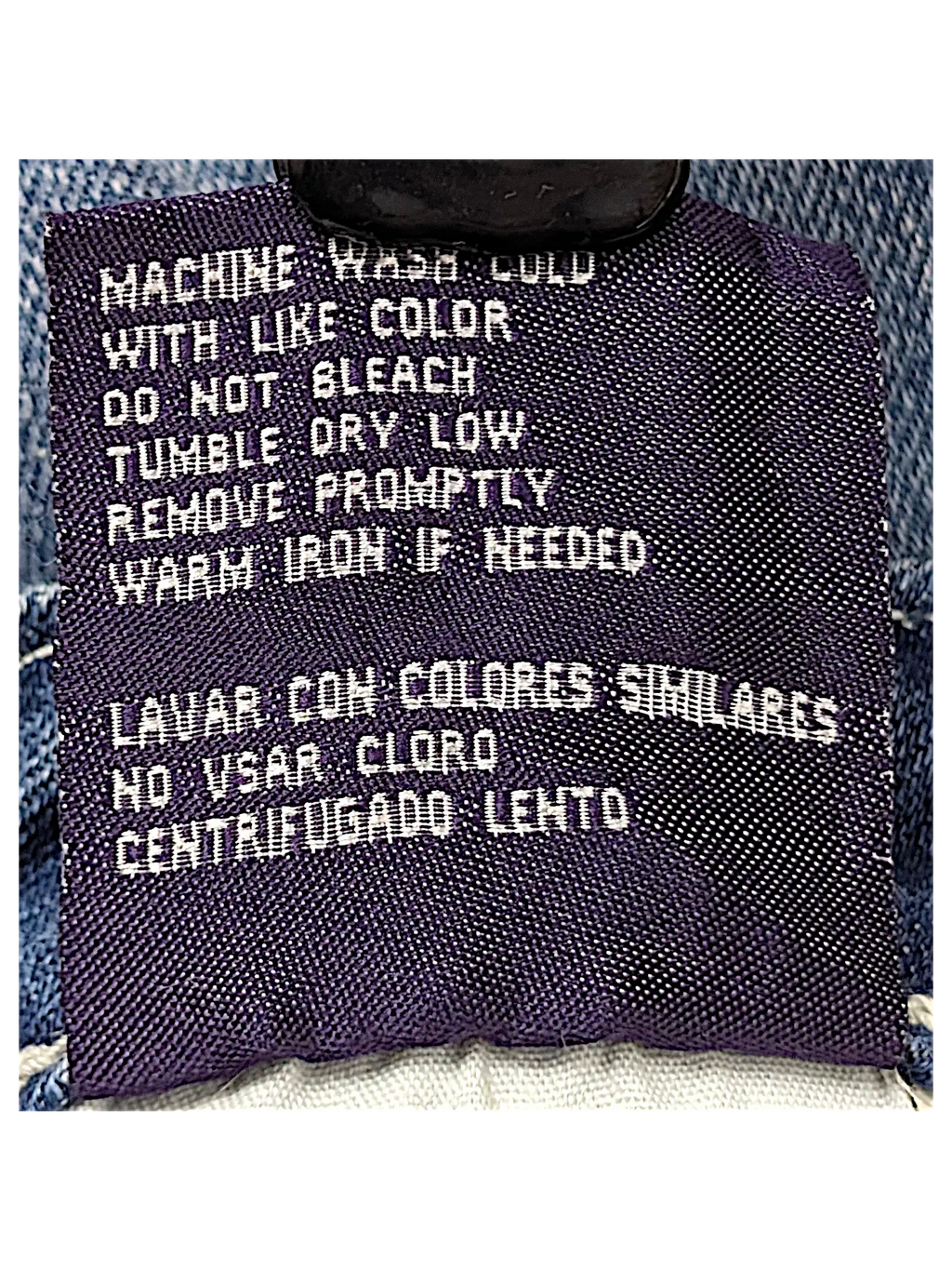 JAKE & IPI Vigoss Flare Jeans 7 care label with washing instructions in English and Spanish on blue denim fabric