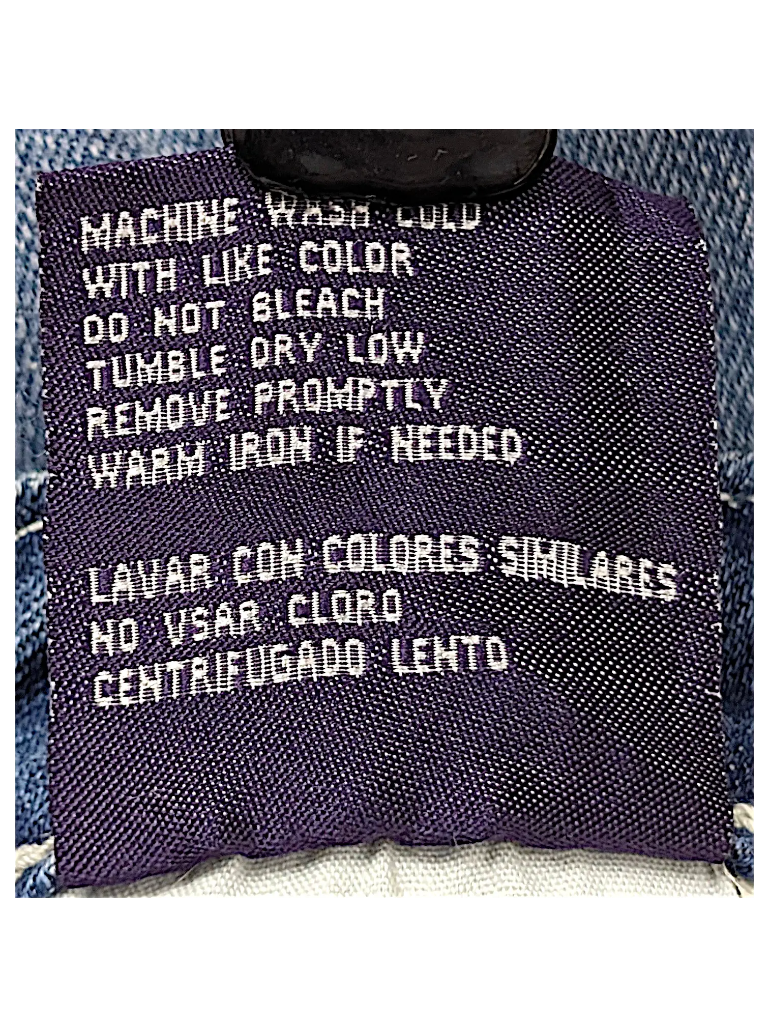 JAKE & IPI Vigoss Flare Jeans 7 care label with washing instructions in English and Spanish on blue denim fabric