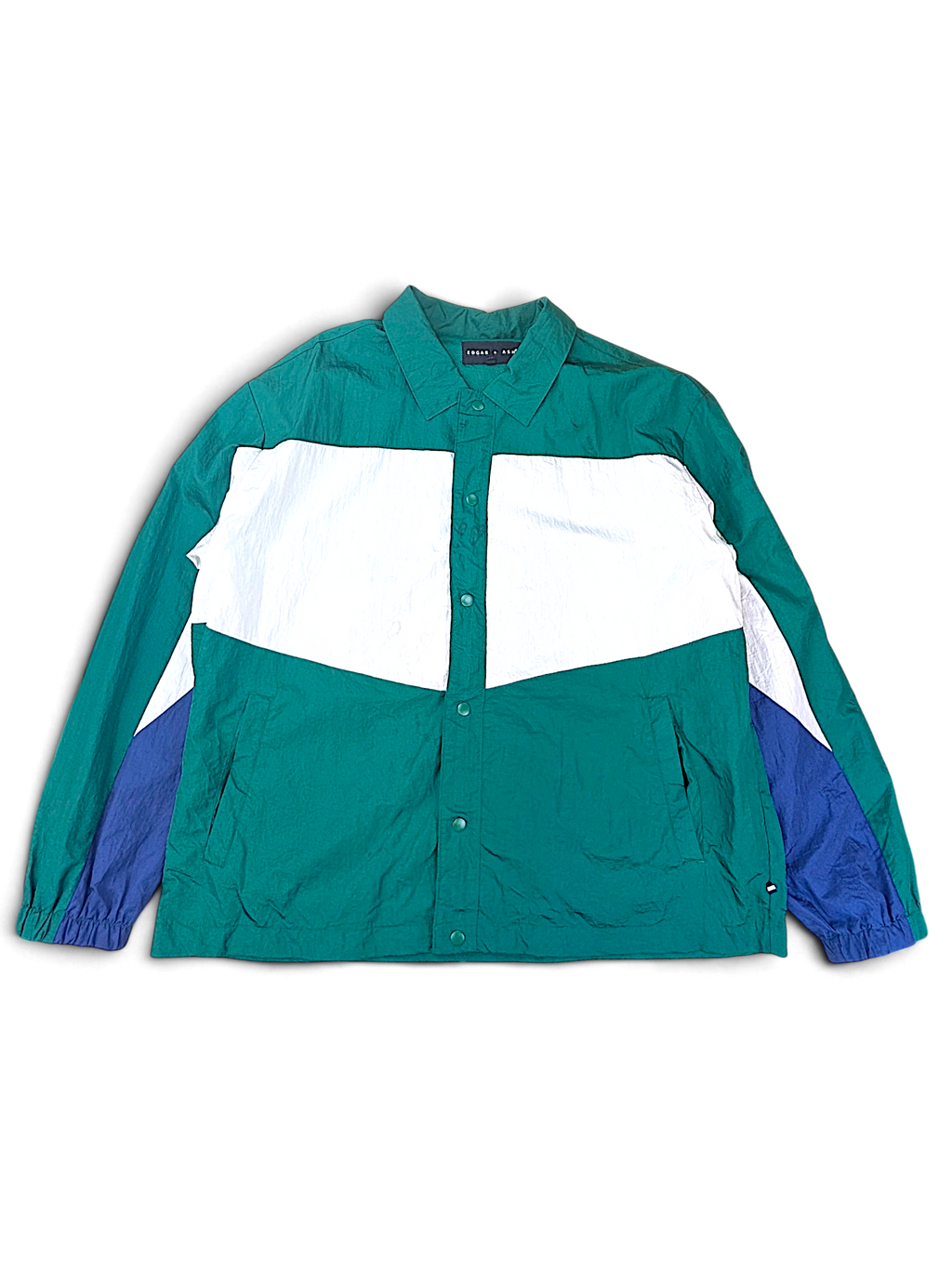 Edgar + Ash Green Colourblock Coach Jacket; Front view with green, white and dark blue panels.