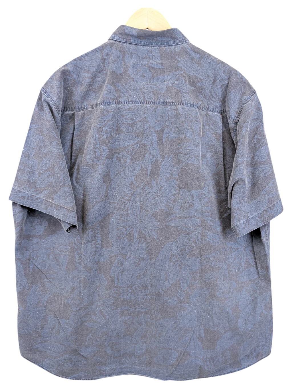 JAKE & IPI vintage 90s blue Hawaiian shirt with a subtle tonal tropical leaf print on a hanger