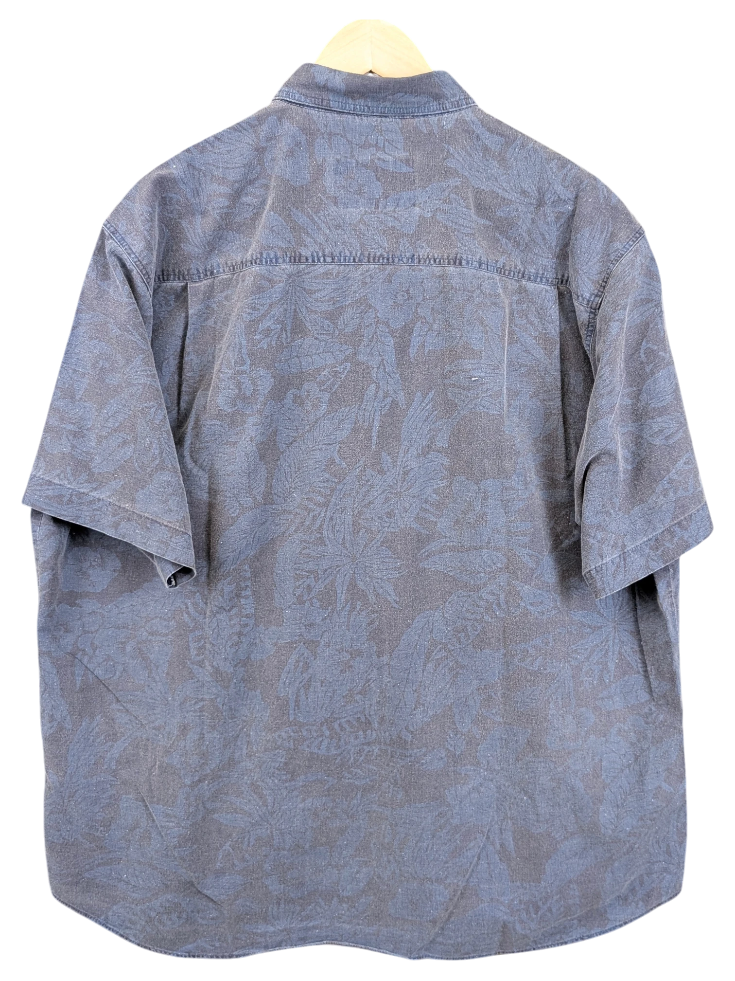 JAKE & IPI vintage 90s blue Hawaiian shirt with a subtle tonal tropical leaf print on a hanger