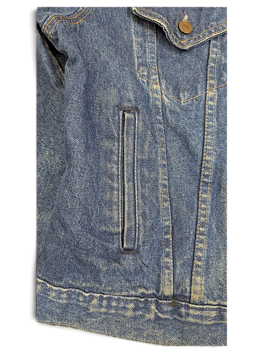 Close-up of a vintage JAKE & IPI Levi's denim jacket featuring blue wash fabric, contrast stitching, and a side pocket.