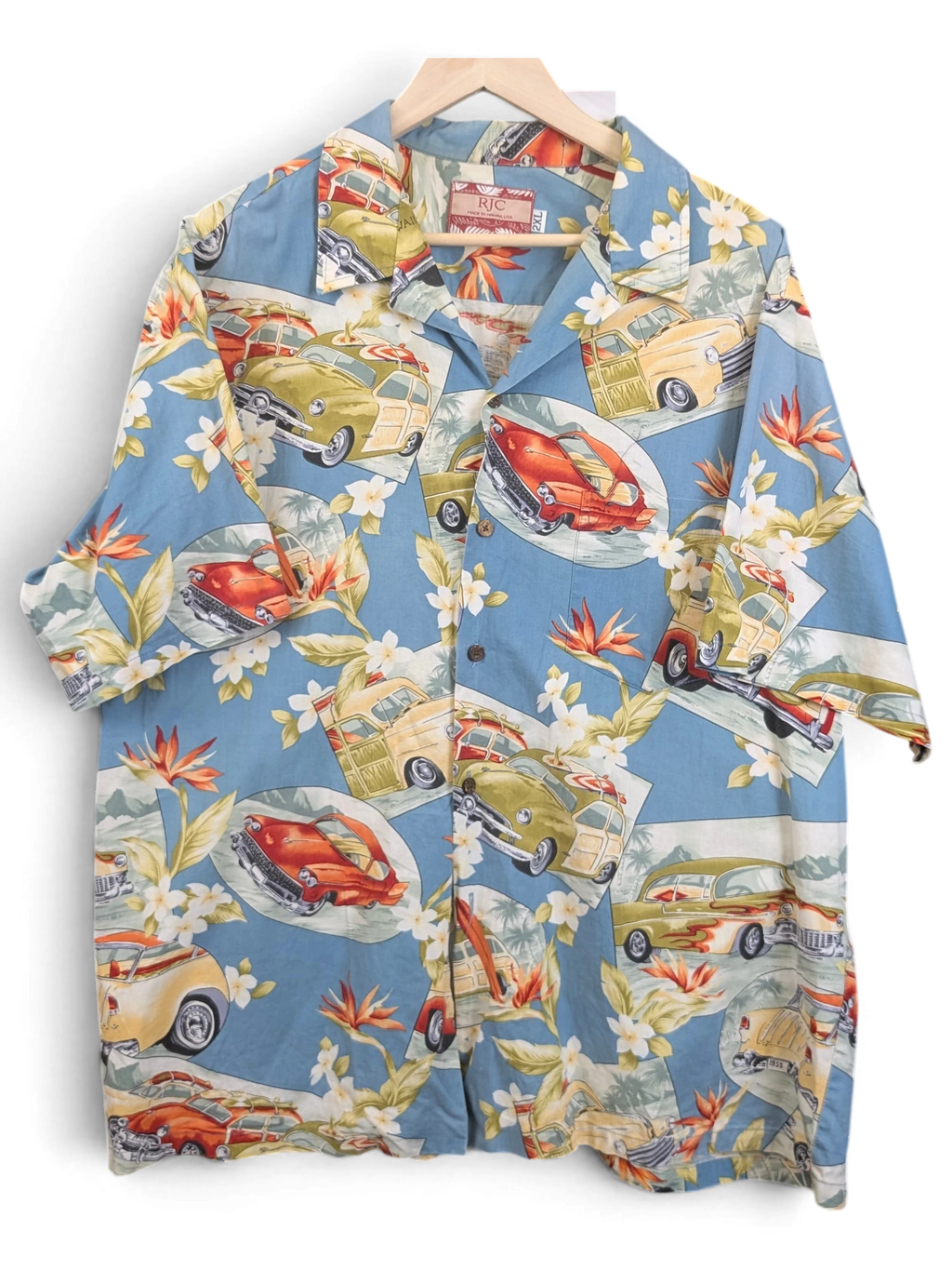 JAKE & IPI vintage RJC Hawaiian shirt in blue with classic car and tropical floral print on a wooden hanger