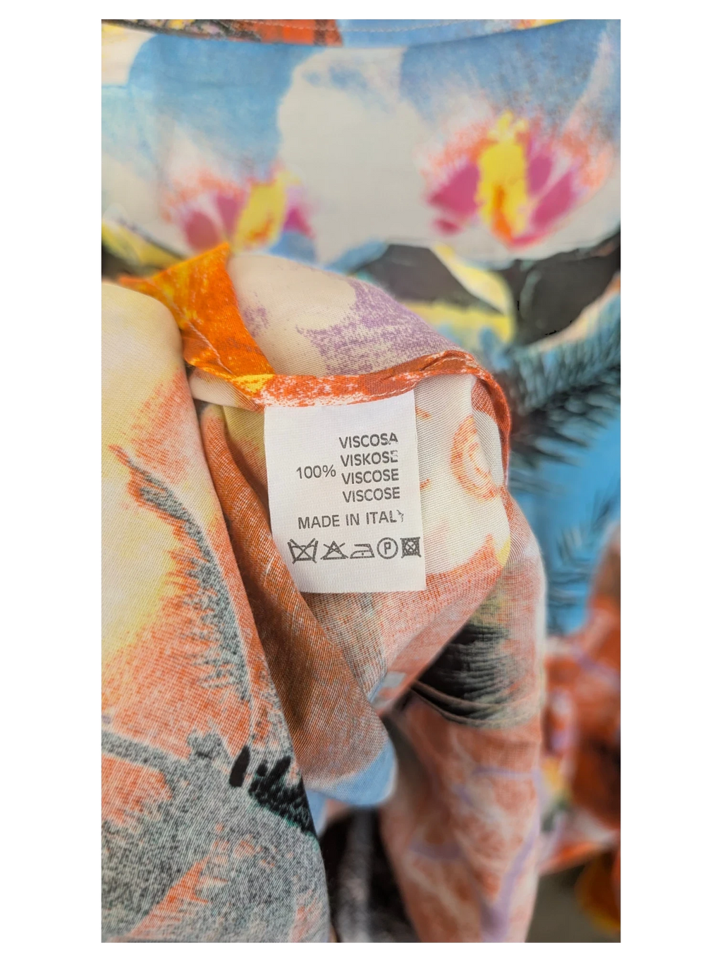 JAKE & IPI Hawaiian shirt label showing 100% viscose material and Made in Italy origin on a floral print fabric