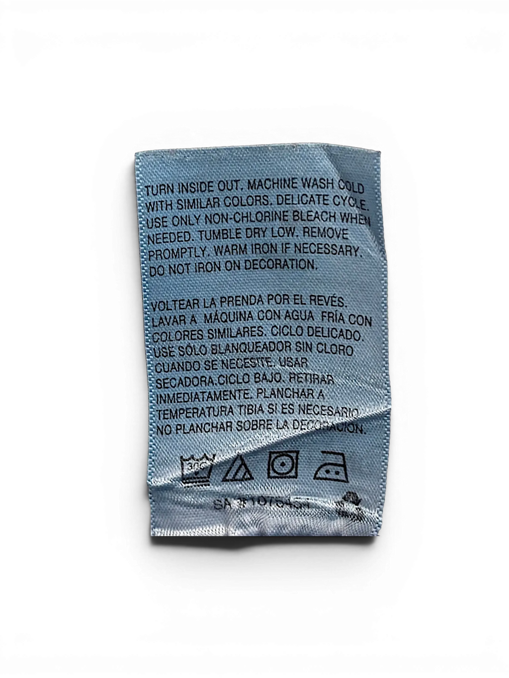 JAKE & IPI Wallflower Plus Long 20 garment care label with washing instructions in English and Spanish