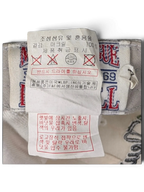 JAKE & IPI white cap interior care label with 100% acrylic composition details and washing instructions