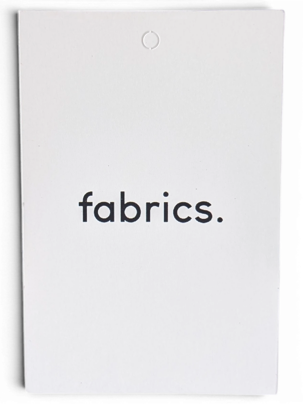 JAKE & IPI white product tag with fabrics. text printed in black, displayed against a dark background.