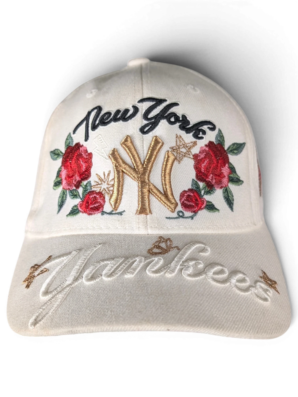 JAKE & IPI white New York Yankees cap featuring gold NY embroidery, red rose floral accents, and script lettering.
