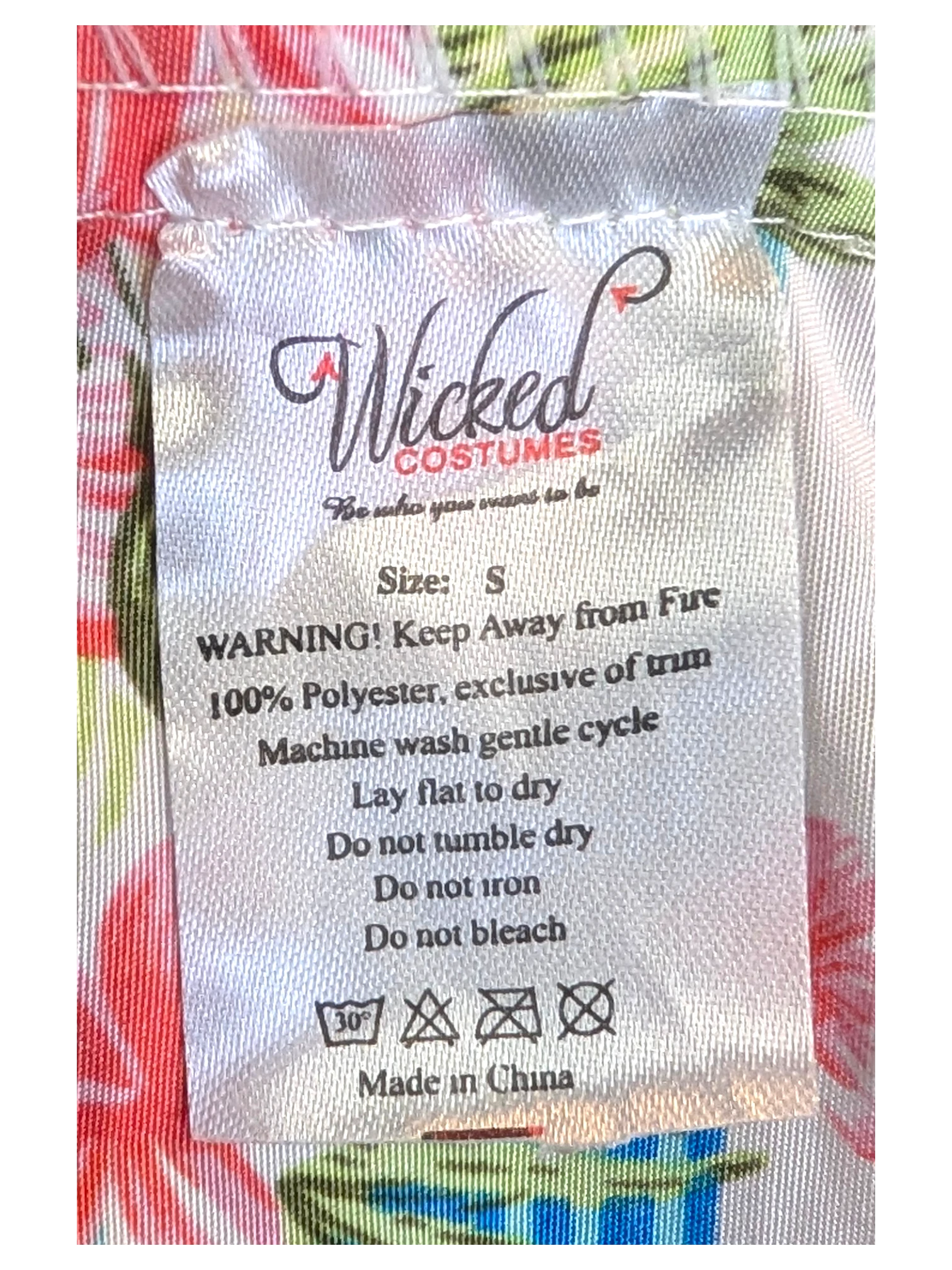 JAKE & IPI Wicked Costumes Hawaiian shirt care label showing 100% polyester material and size small