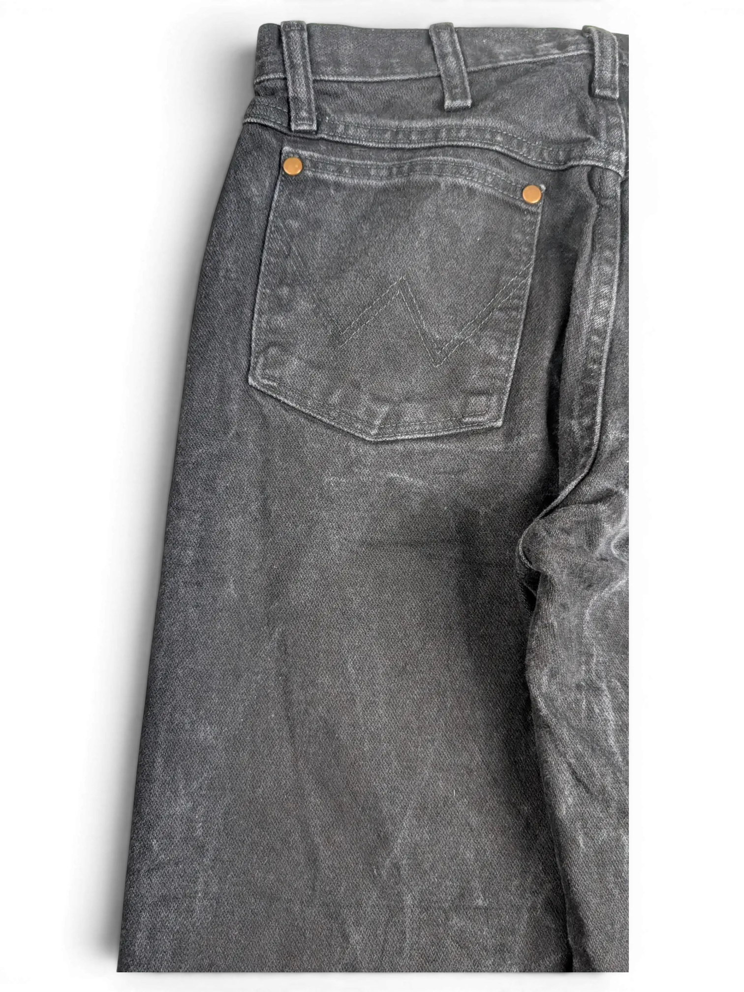 JAKE & IPI Wrangler A203 black denim jeans featuring back pockets with signature stitching and copper rivets.
