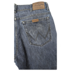 JAKE & IPI Wrangler blue denim jeans featuring a classic five-pocket design and leather brand patch on the back.