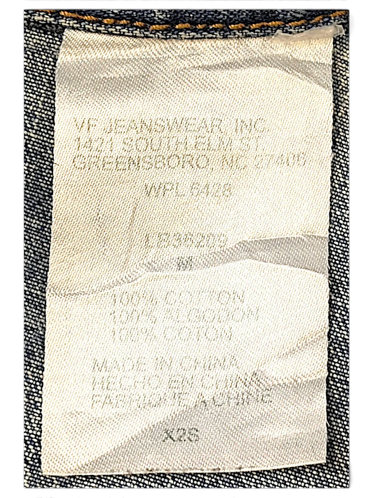 JAKE & IPI Wrangler blues denim jacket interior care label showing 100 percent cotton material composition
