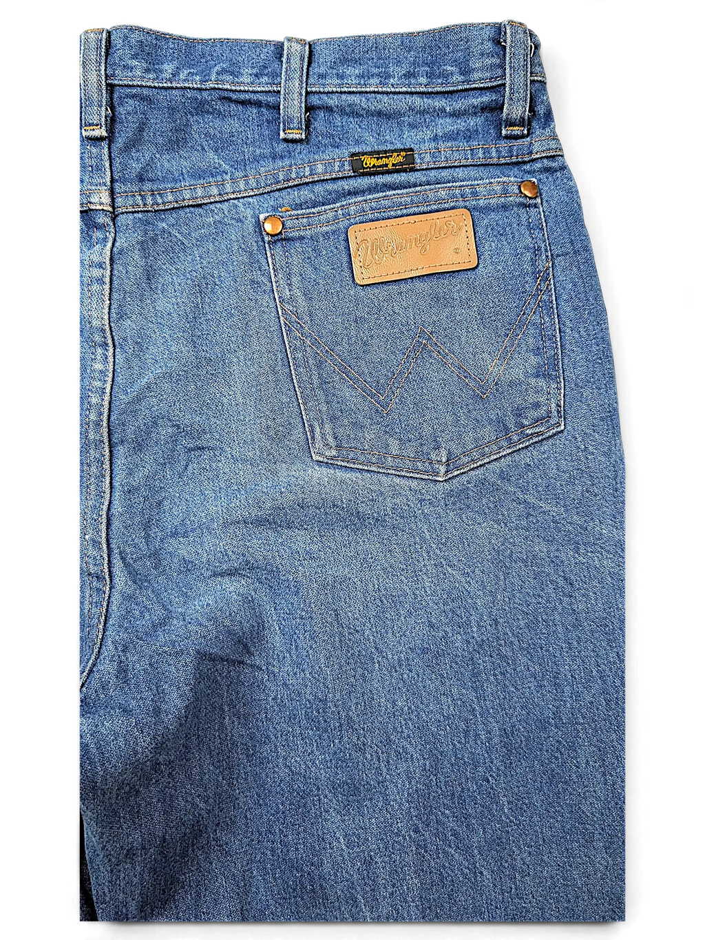 JAKE & IPI Wrangler 936DEN blue denim jeans featuring a leather patch and signature W stitching on the back pocket.