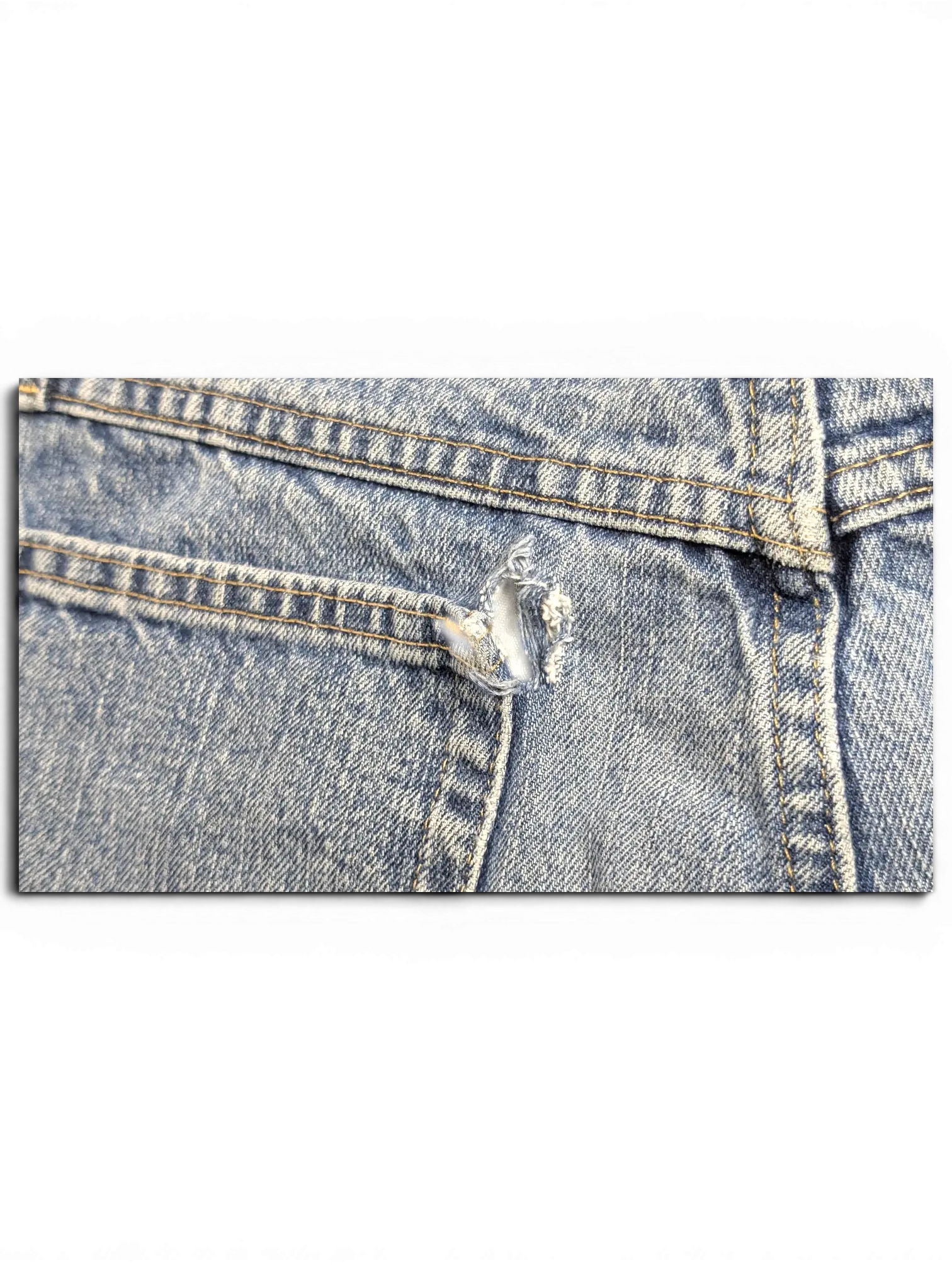 JAKE & IPI Wrangler jeans in light blue denim featuring a small distressed tear near the back pocket seam