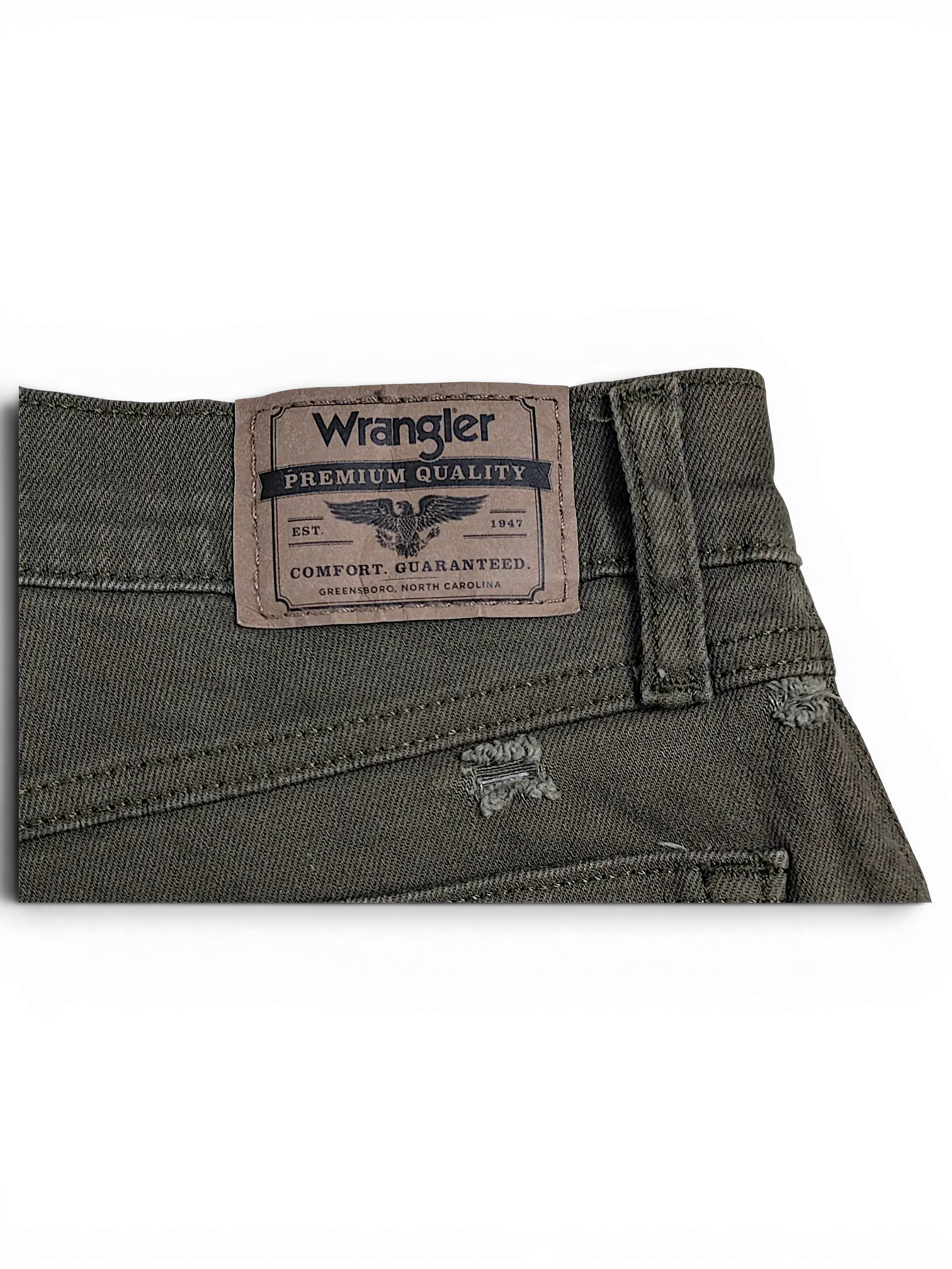JAKE & IPI Wrangler green athletic fit jeans featuring a brown leather brand patch and distressed denim details.