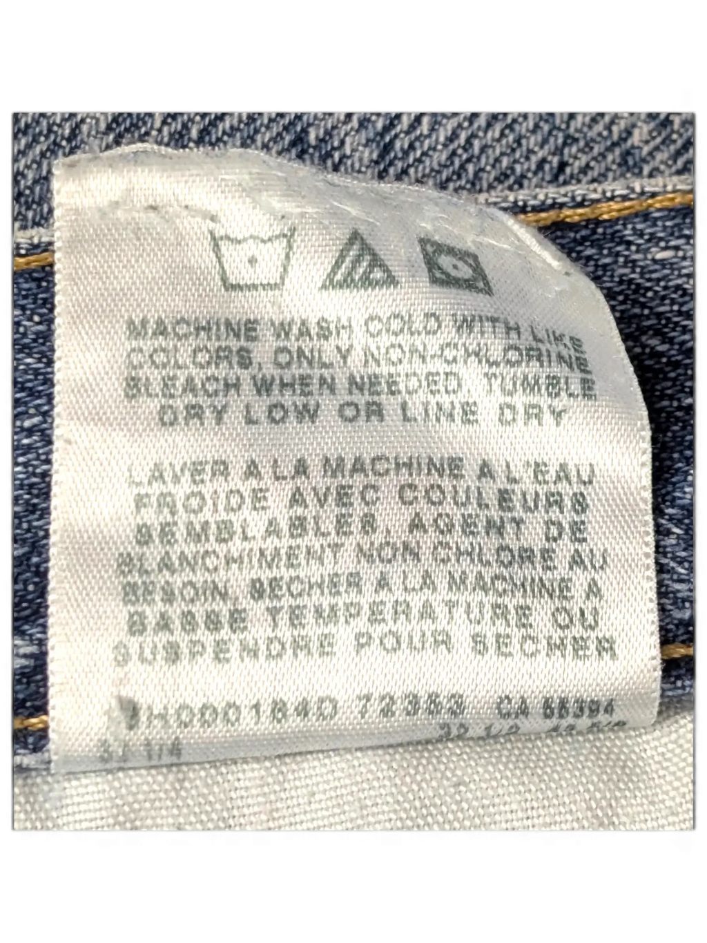 JAKE & IPI Wrangler jeans care label with washing instructions on blue denim fabric