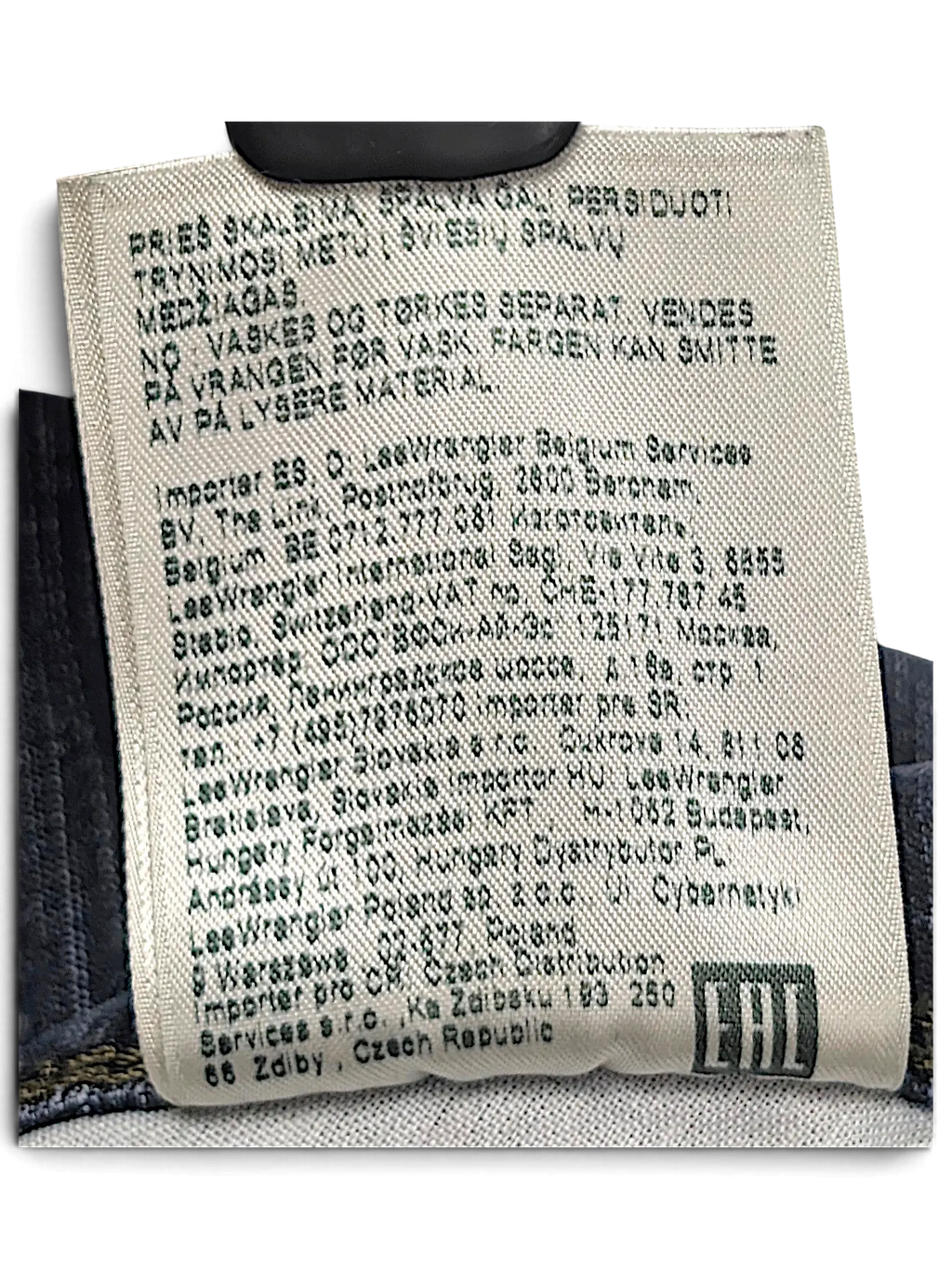 JAKE & IPI Wrangler jeans care label with manufacturing and import information in multiple languages